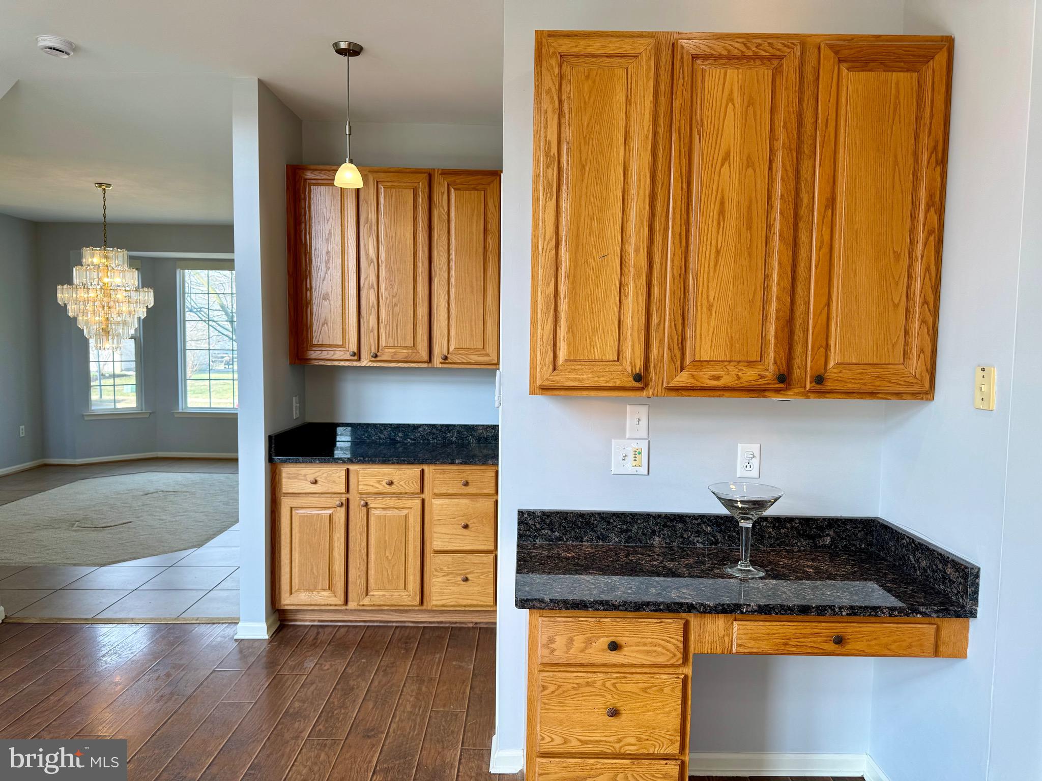 4 Hogan Circle Middletown, DE 19709 - Photo 16 of 60 a kitchen with granite countertop cabinets and black appliances