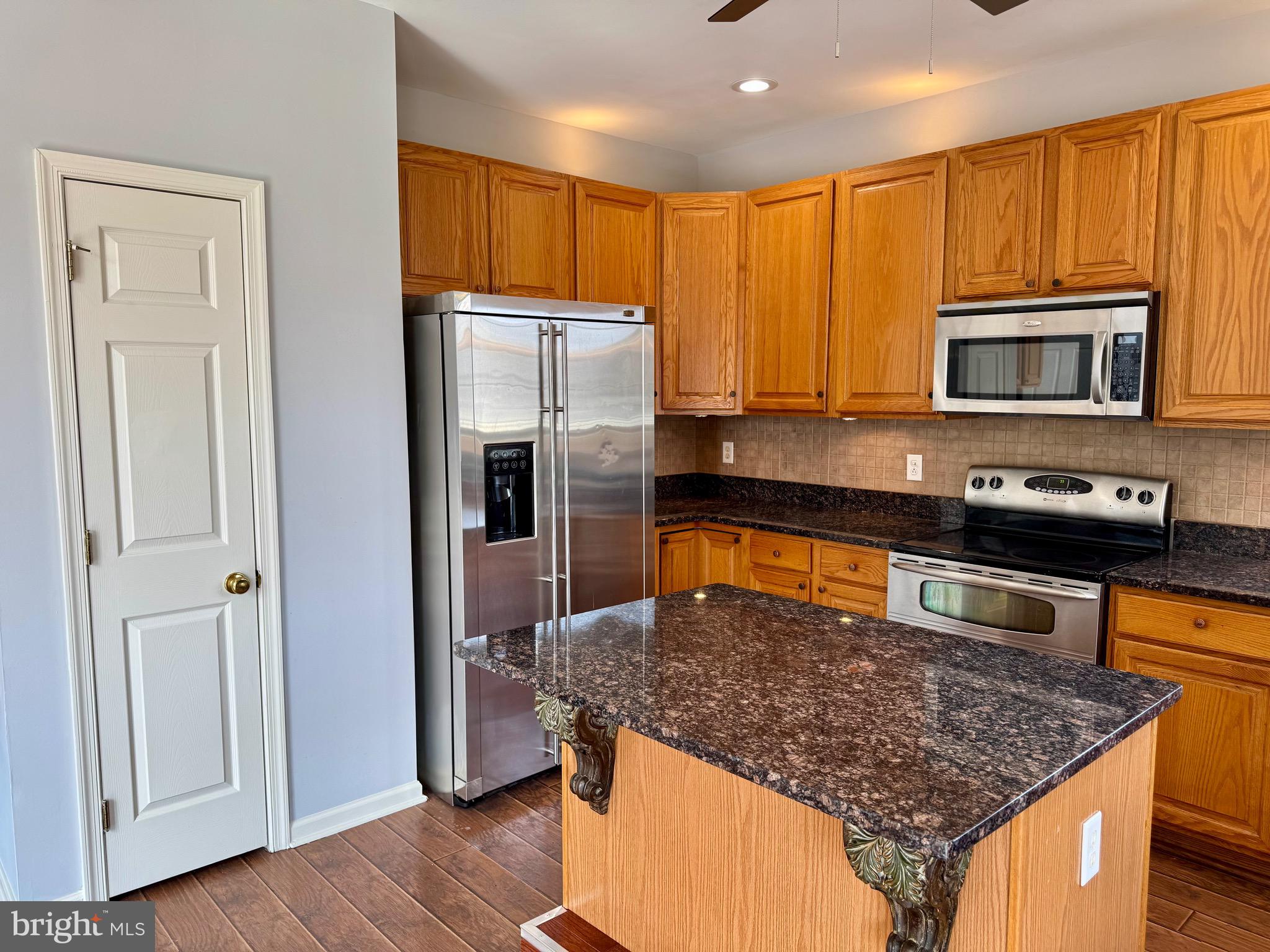 4 Hogan Circle Middletown, DE 19709 - Photo 18 of 60 a kitchen with stainless steel appliances granite countertop a stove a refrigerator and a microwave