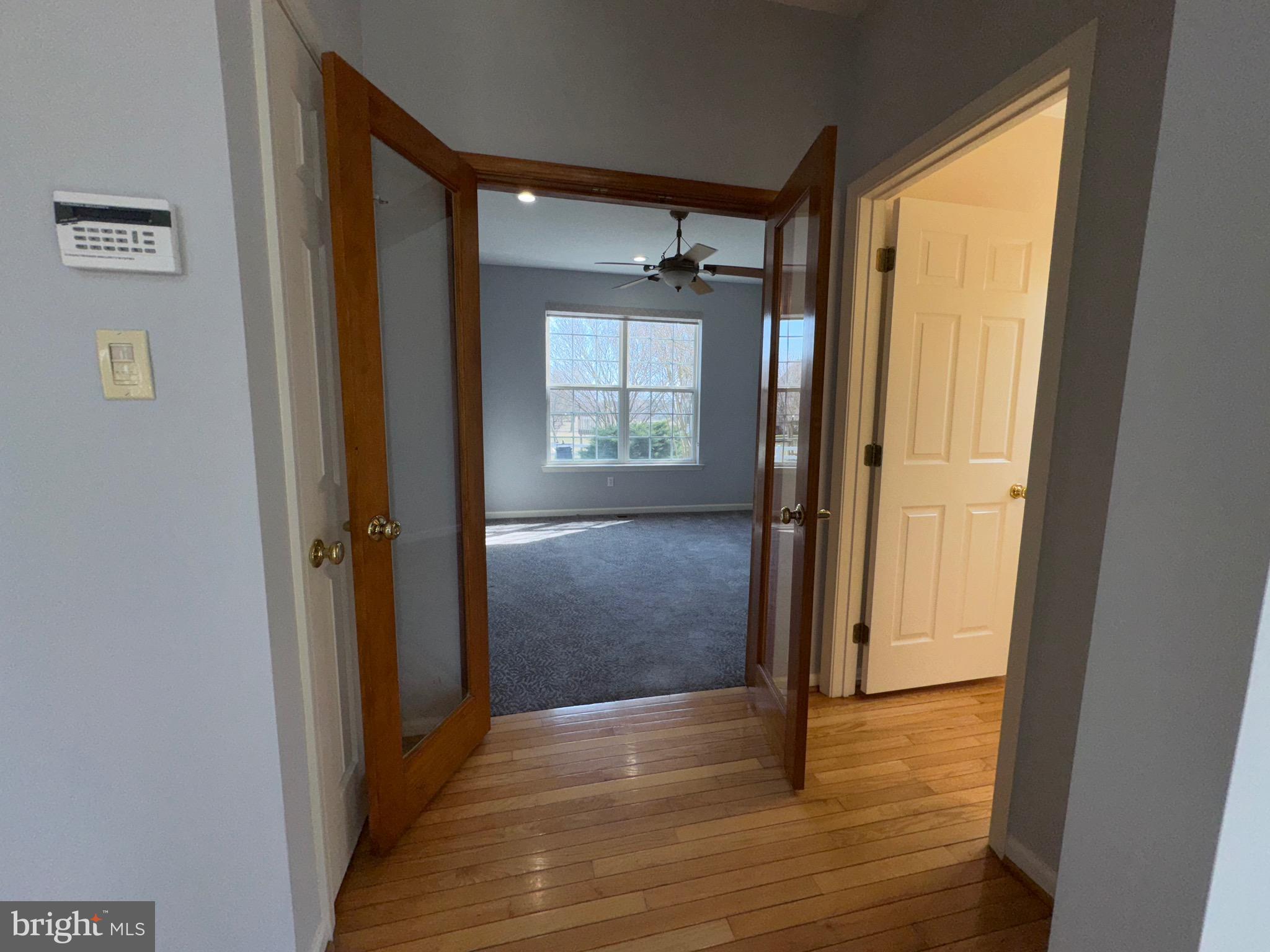 4 Hogan Circle Middletown, DE 19709 - Photo 8 of 60 a view of a hallway with wooden floor and a cabinet