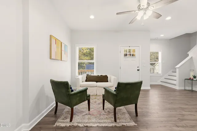 a living room with furniture and kitchen view