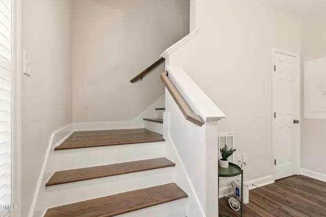 a view of entryway with stairs and wooden floor