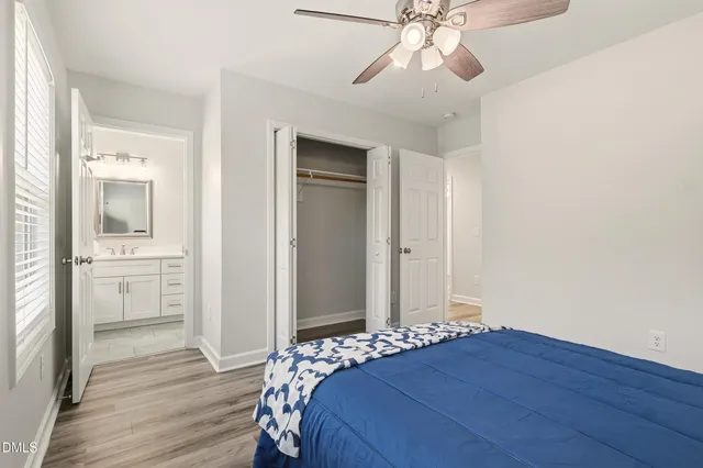 a bedroom with a large bed and a window