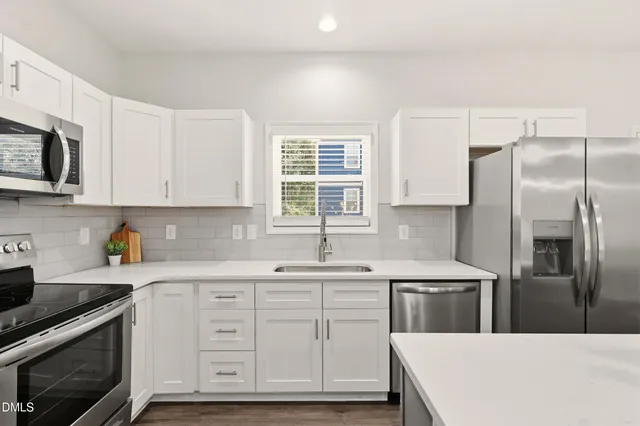 a kitchen with a sink and steel appliances