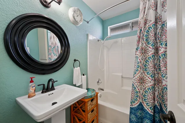 a bedroom with a bed and a flat tv screen on dresser