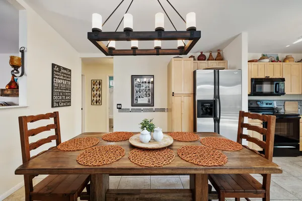 a kitchen with stainless steel appliances granite countertop a sink and a refrigerator