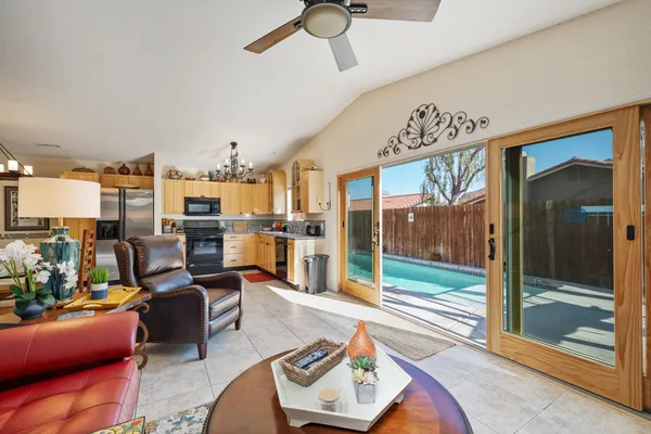 a living room with furniture a rug and a window