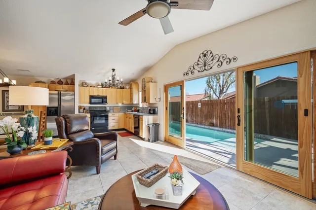 a living room with furniture a rug and a window