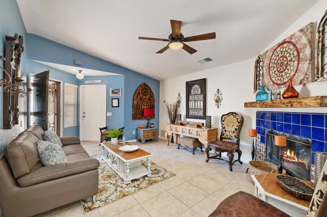 a living room with lots of furniture and paintings on the wall