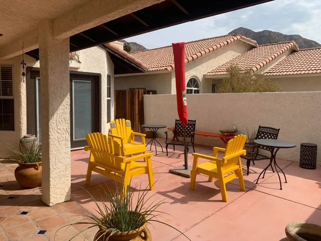 a view of a patio with table and chairs and potted plants