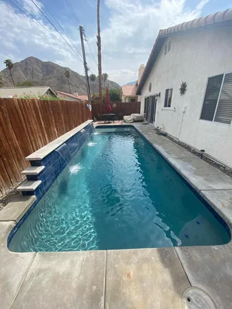 a view of a backyard with sitting area