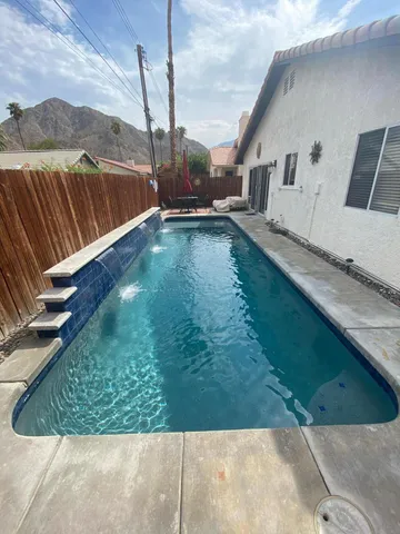 a view of a backyard with sitting area