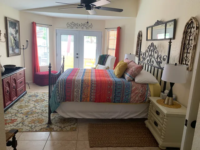 a bedroom with a bed and lamp with the dresser