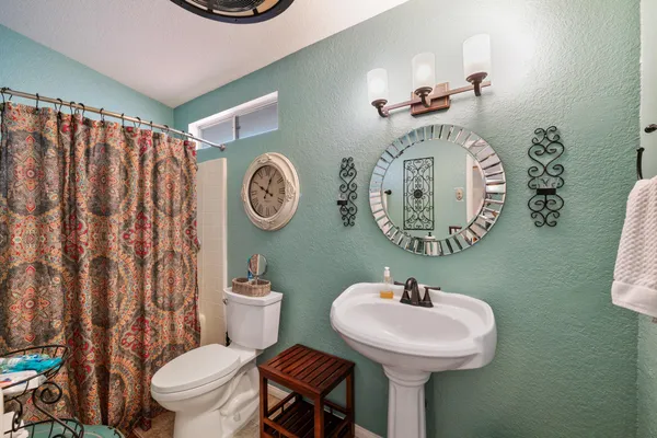 a living room with furniture a flat screen tv and a large window