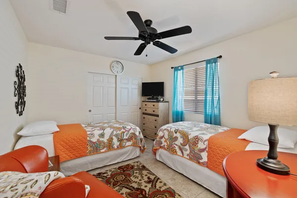 a bedroom with a bed and ceiling fan