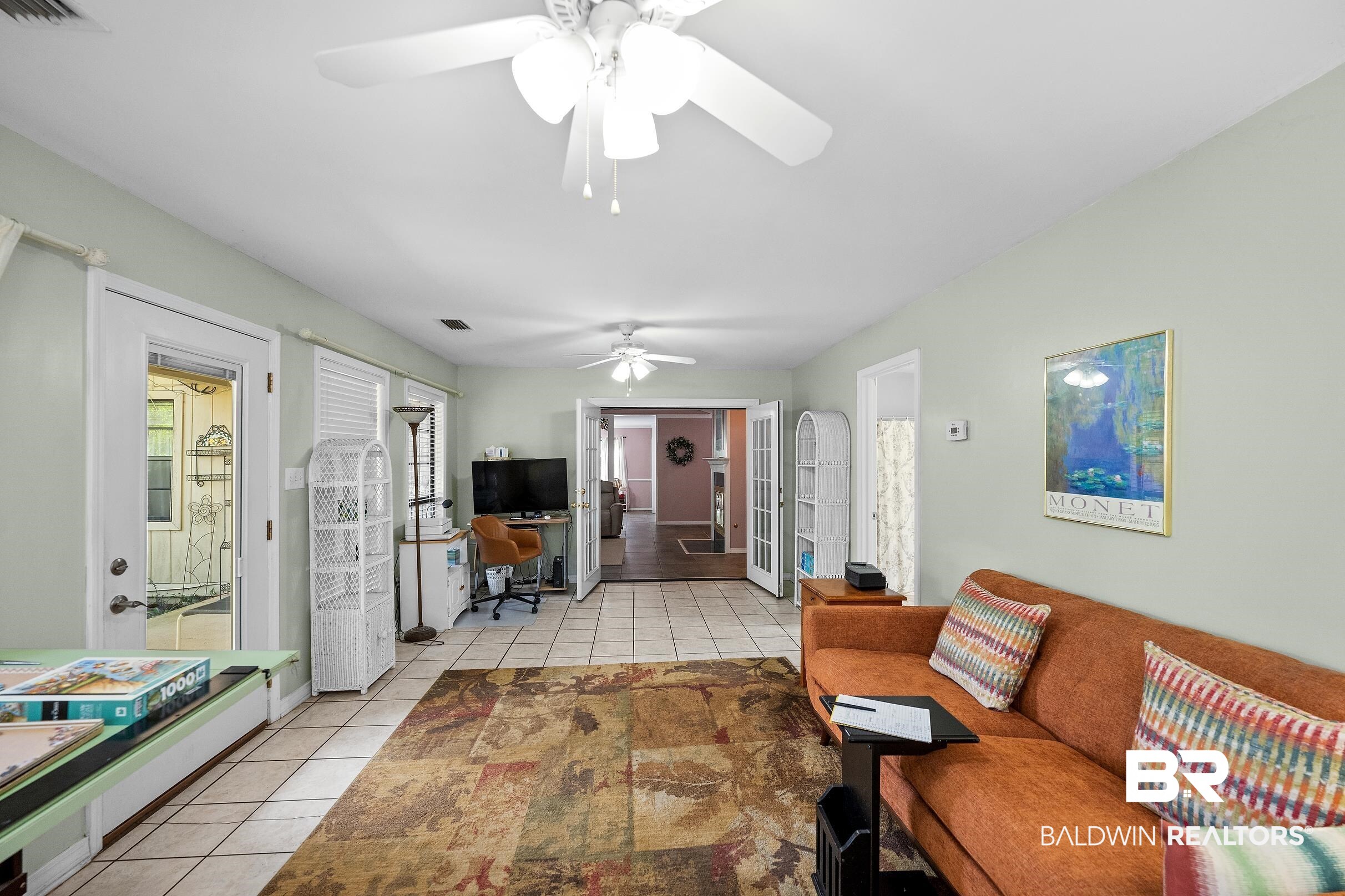 4026 Kingsrow Row Mobile, AL 36619 - Photo 17 of 51 Living room with light tile patterned floors, a ceiling fan, and a desk