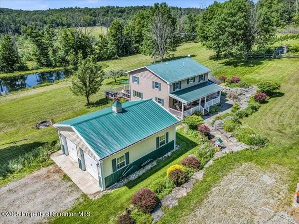 an aerial view of a house with a big yard