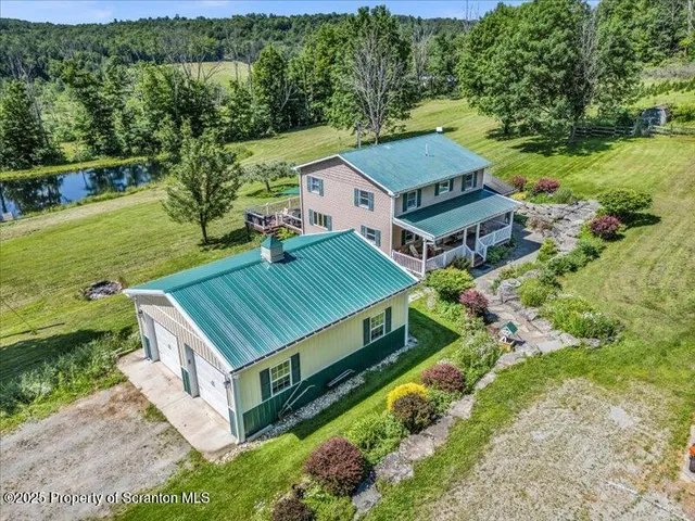 an aerial view of a house with a big yard