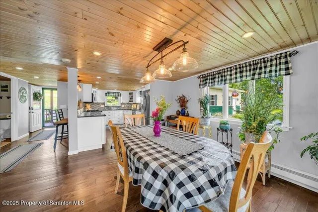 a view of a dining room with furniture wooden floor and a chandelier