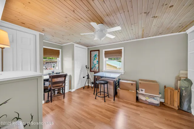 a view of a workspace with furniture window and wooden floor