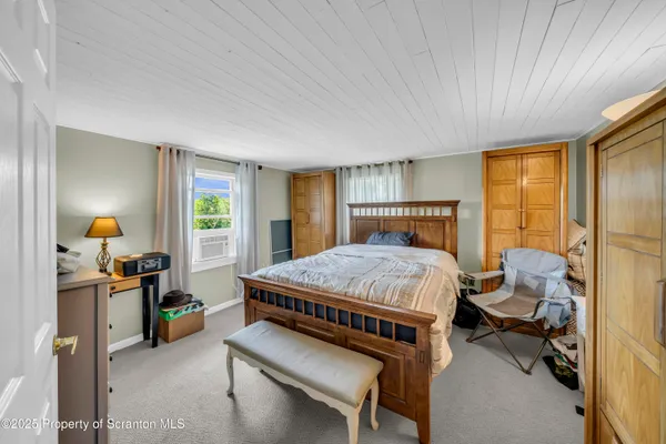 a bed sitting in a room next to a window