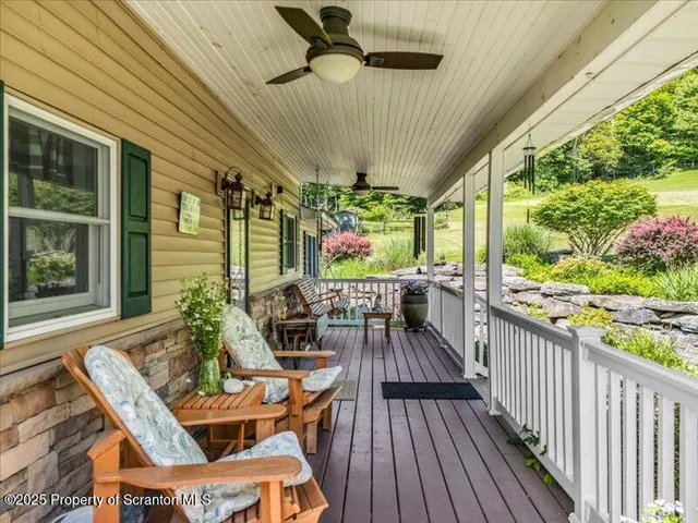 a view of a patio with table and chairs potted plants with wooden floor