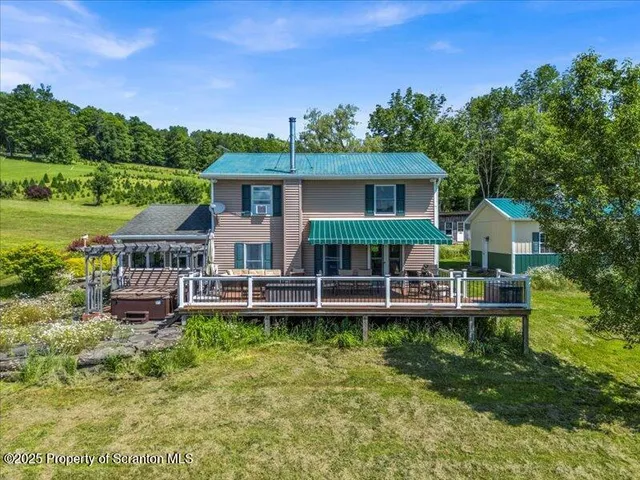 a front view of a house with a yard table and chairs
