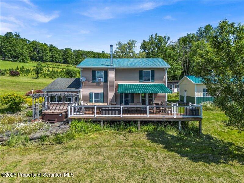 1715 Booth Road Hallstead, PA 18822 - Photo 28 of 39 a front view of a house with a yard table and chairs
