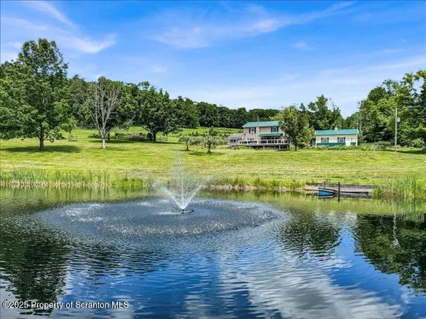 a view of a lake with houses in the back