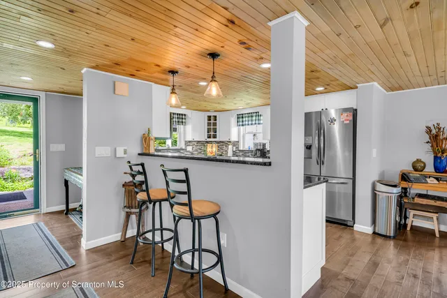 a kitchen with stainless steel appliances a refrigerator and a table