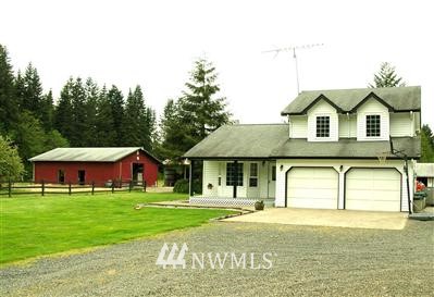 200-60 Dorning Road Winlock, WA 98596 - Photo 1 of 1 a front view of a house with a garden and porch