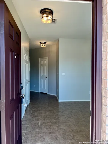 a view of a hallway with a room