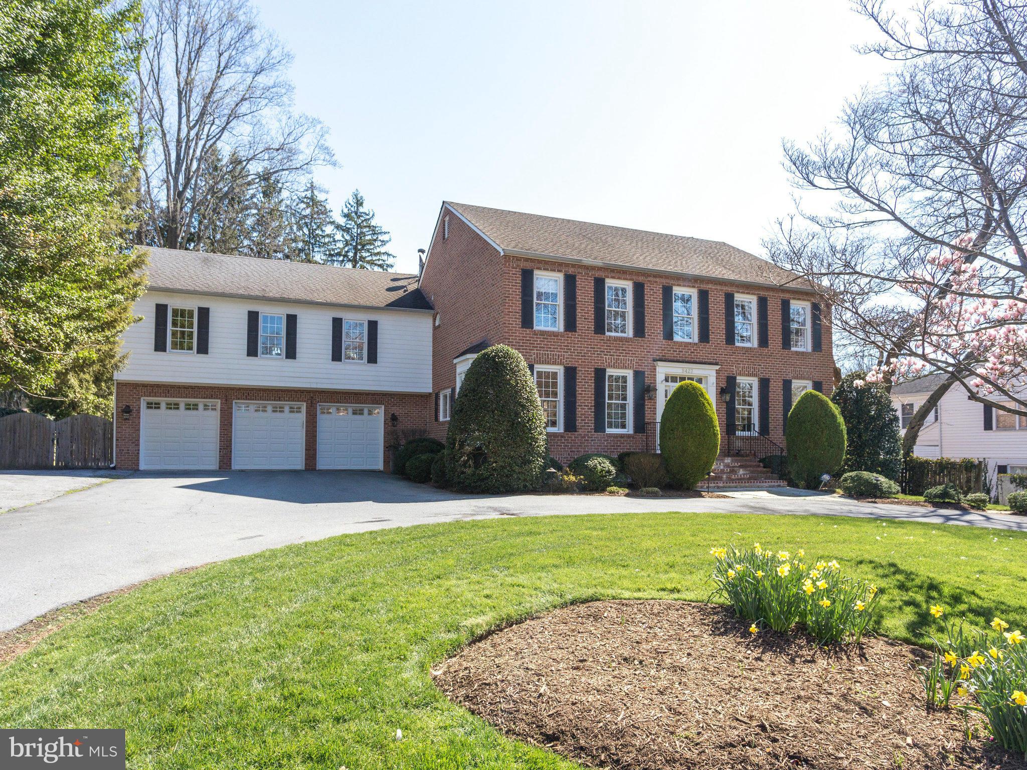 9423 Seven Locks Road Bethesda, MD 20817 - Photo 2 of 28 a front view of a house with a yard and garage