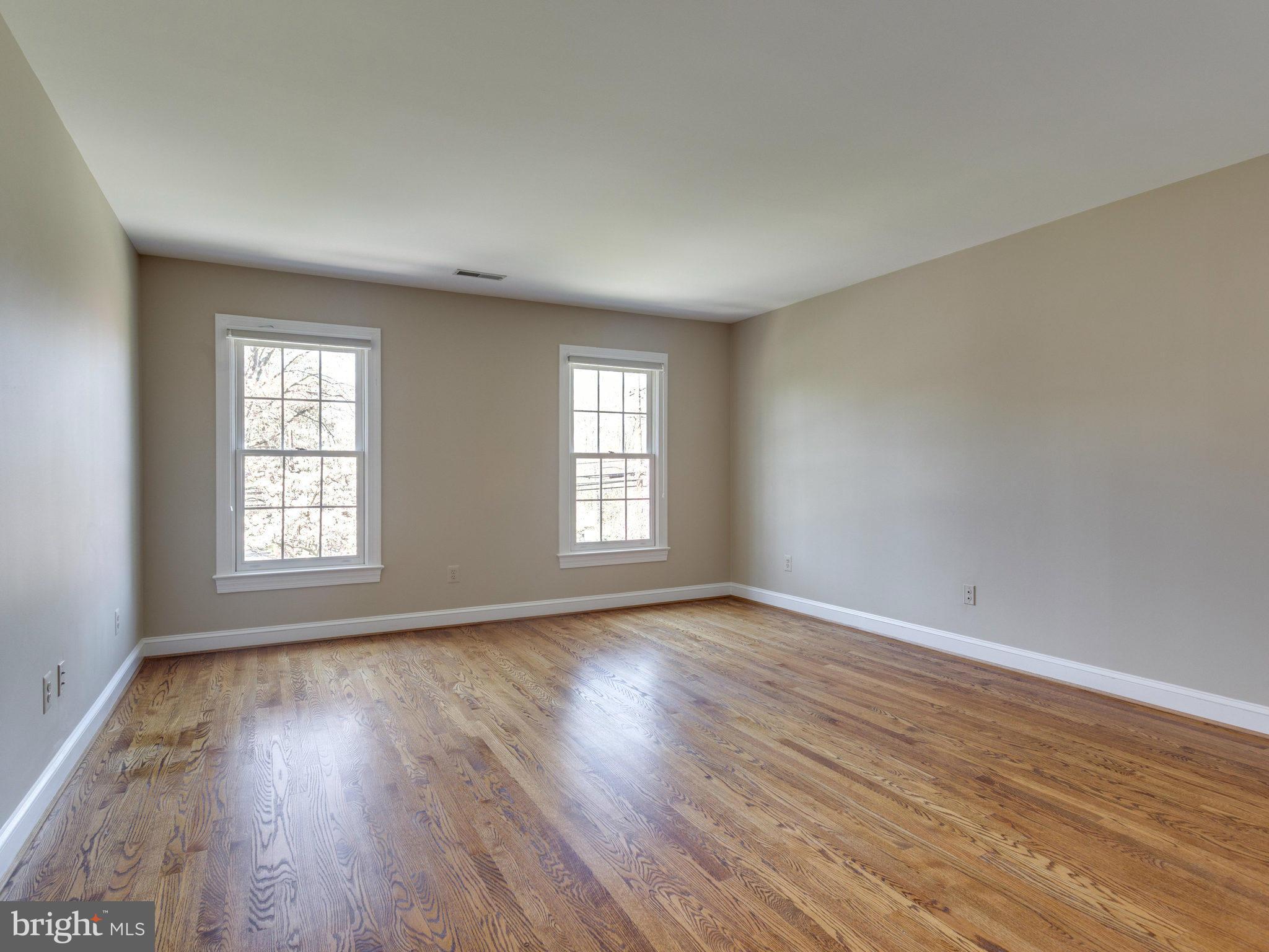 9423 Seven Locks Road Bethesda, MD 20817 - Photo 22 of 28 a view of an empty room with wooden floor and window