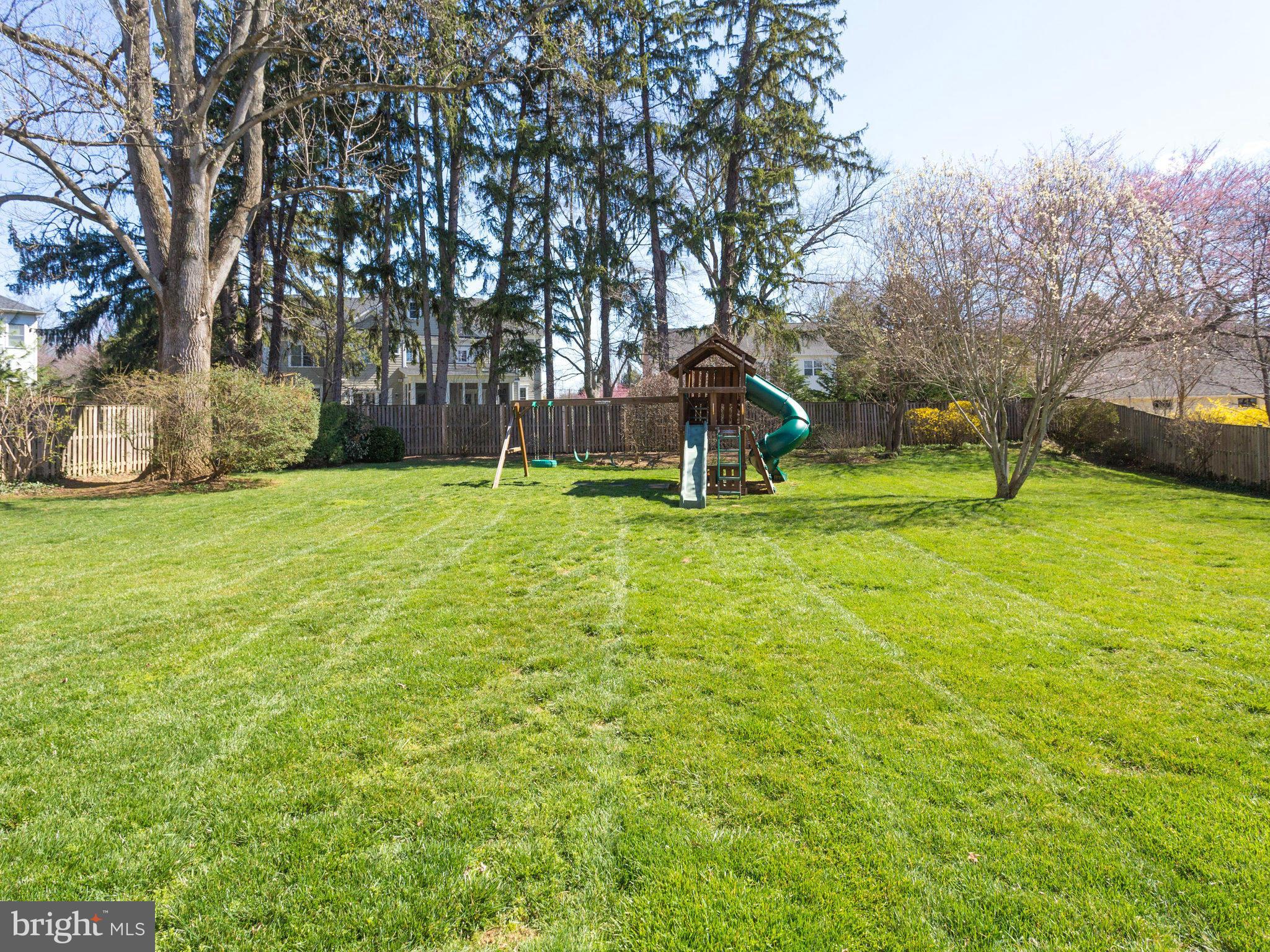 9423 Seven Locks Road Bethesda, MD 20817 - Photo 27 of 28 a white house with a big yard and large trees