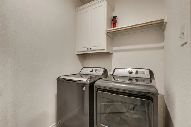 a view of a kitchen with a sink and chandelier