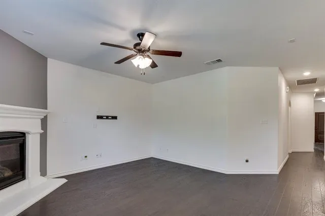 wooden floor in an empty room with a fireplace