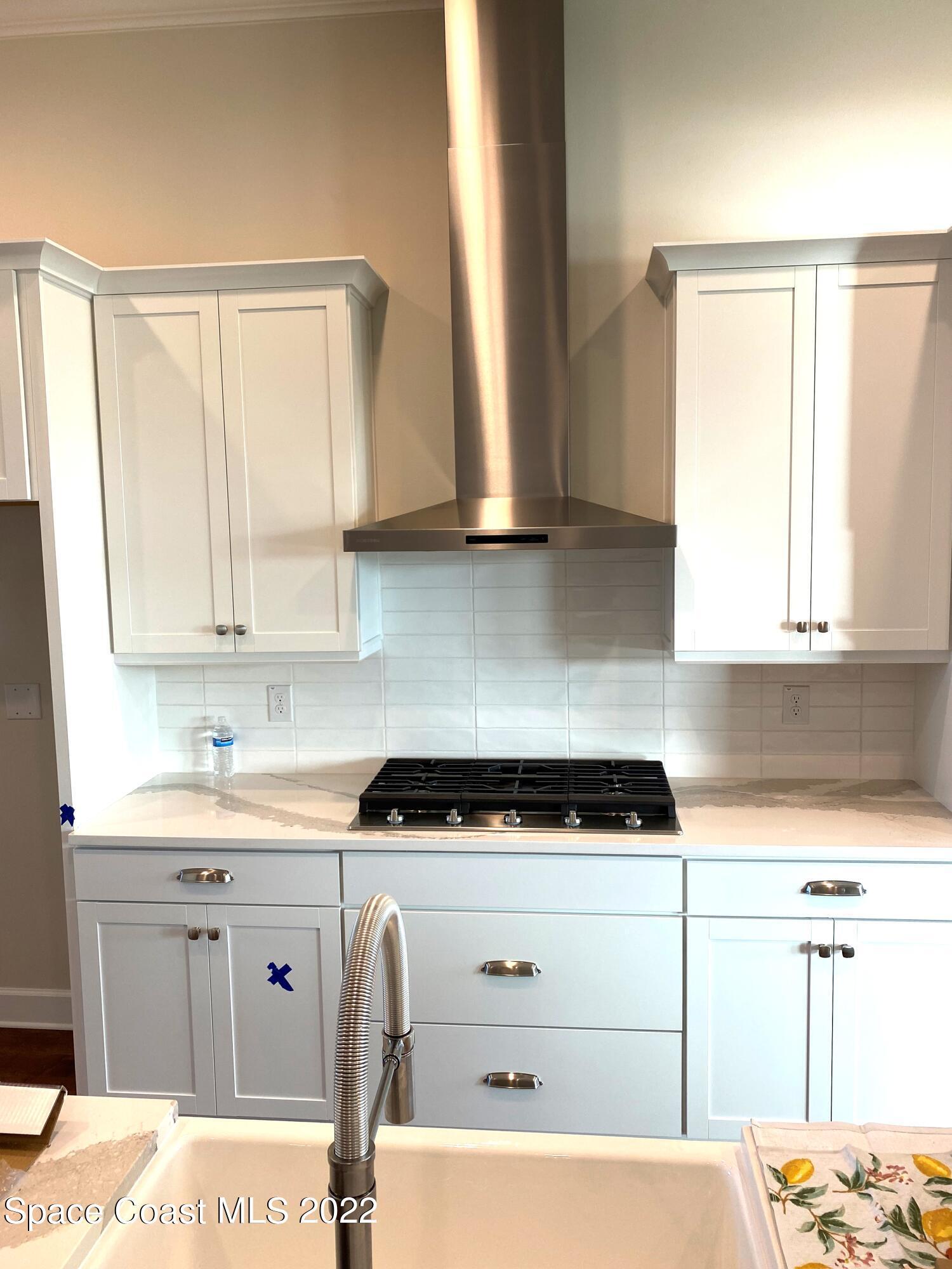 8321 Paragrass Avenue Melbourne, FL 32940 - Photo 12 of 41 a kitchen with a sink and cabinets