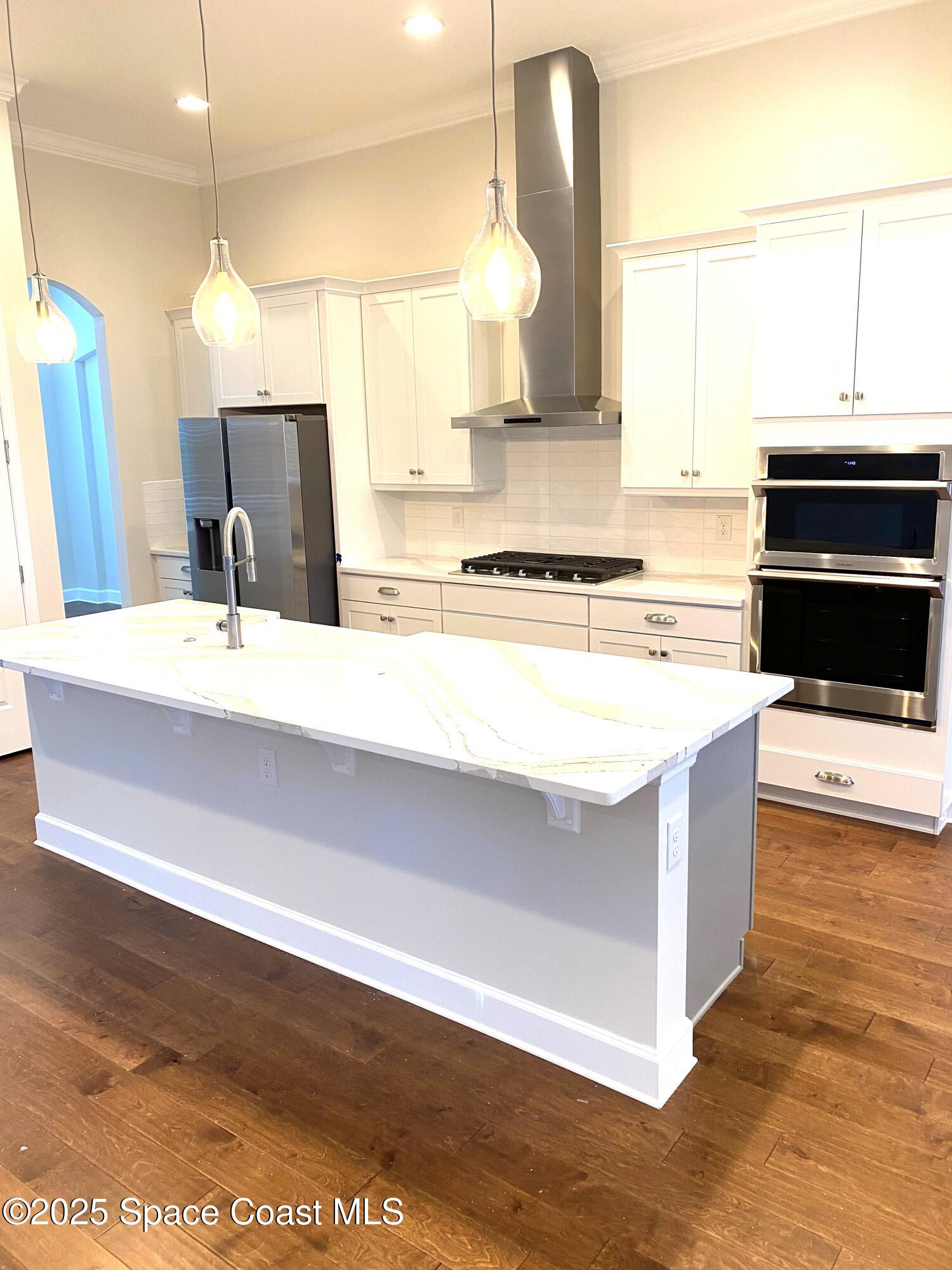 8321 Paragrass Avenue Melbourne, FL 32940 - Photo 13 of 41 a kitchen with a stove and a sink