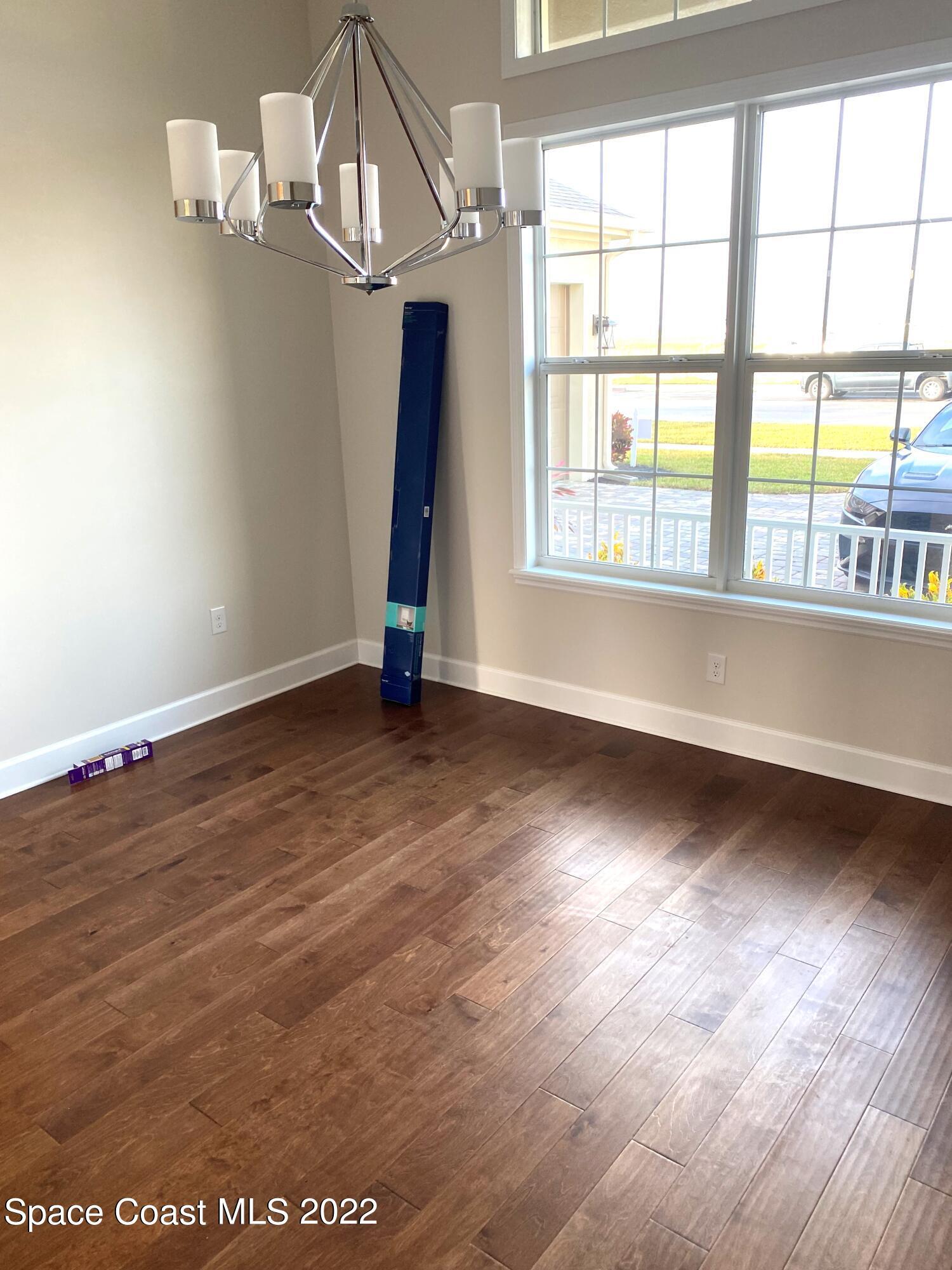 8321 Paragrass Avenue Melbourne, FL 32940 - Photo 14 of 41 wooden floor in an empty room with a window