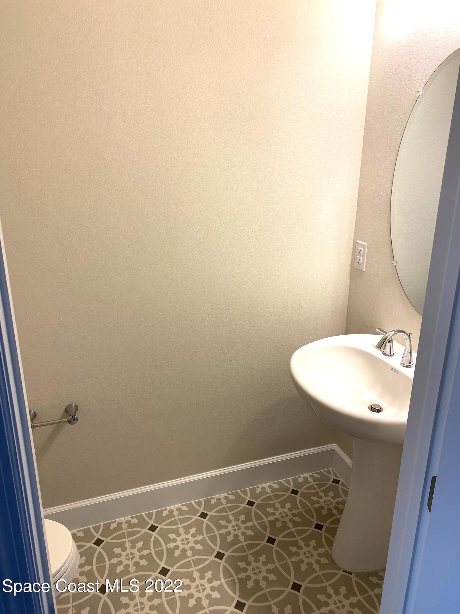 8321 Paragrass Avenue Melbourne, FL 32940 - Photo 15 of 41 a bathroom with a sink and a mirror