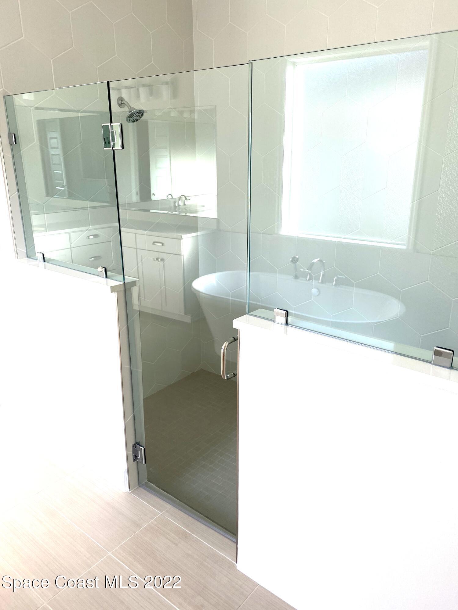 8321 Paragrass Avenue Melbourne, FL 32940 - Photo 21 of 41 a bathroom with a sink and a mirror