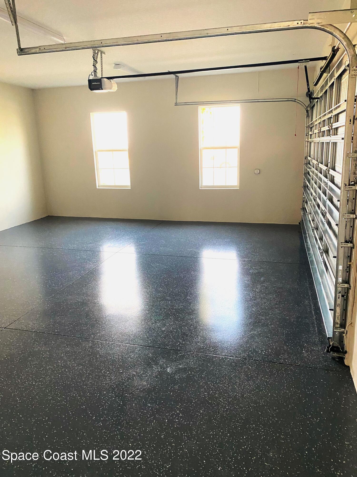 8321 Paragrass Avenue Melbourne, FL 32940 - Photo 34 of 41 a view of a room with window and wooden floor