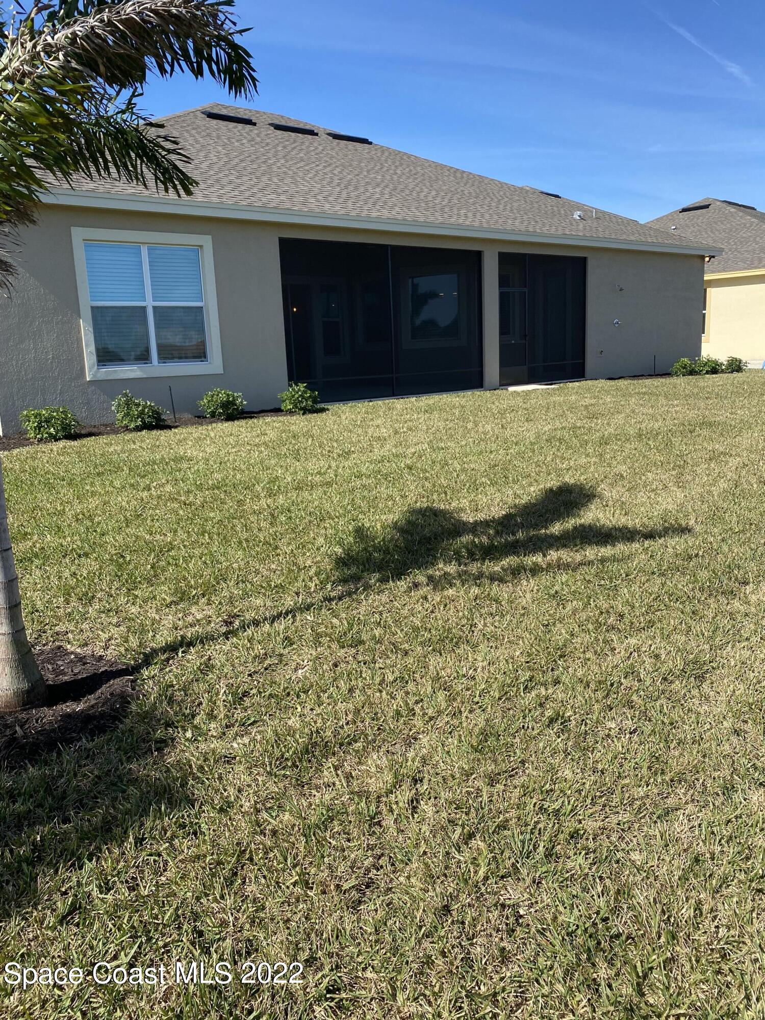 8321 Paragrass Avenue Melbourne, FL 32940 - Photo 36 of 41 a house with yard