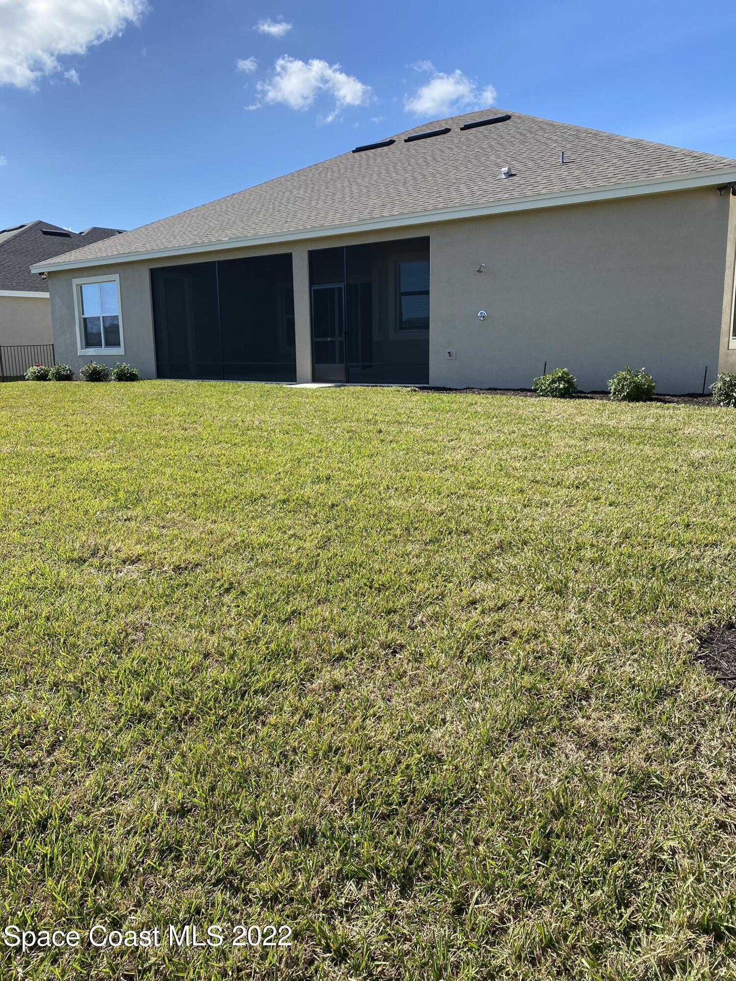 8321 Paragrass Avenue Melbourne, FL 32940 - Photo 37 of 41 a house with a yard