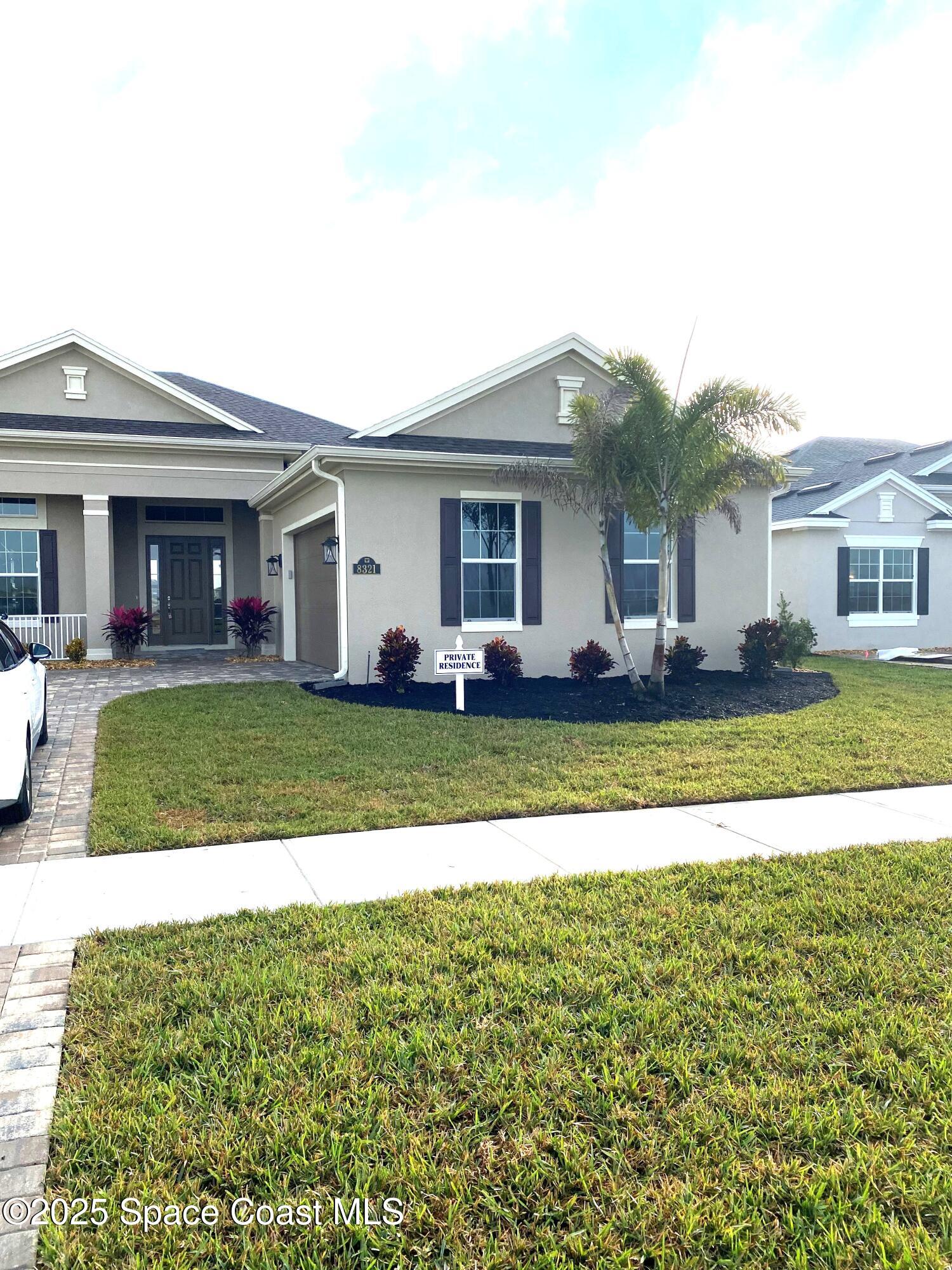 8321 Paragrass Avenue Melbourne, FL 32940 - Photo 4 of 41 a front view of a house with a yard table and chairs