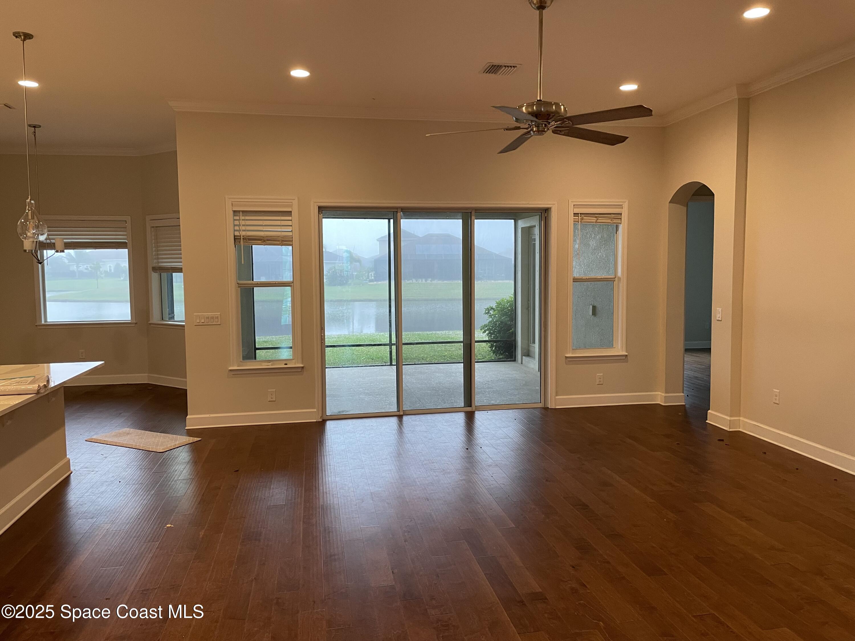 8321 Paragrass Avenue Melbourne, FL 32940 - Photo 8 of 41 a view of an empty room with window and wooden floor