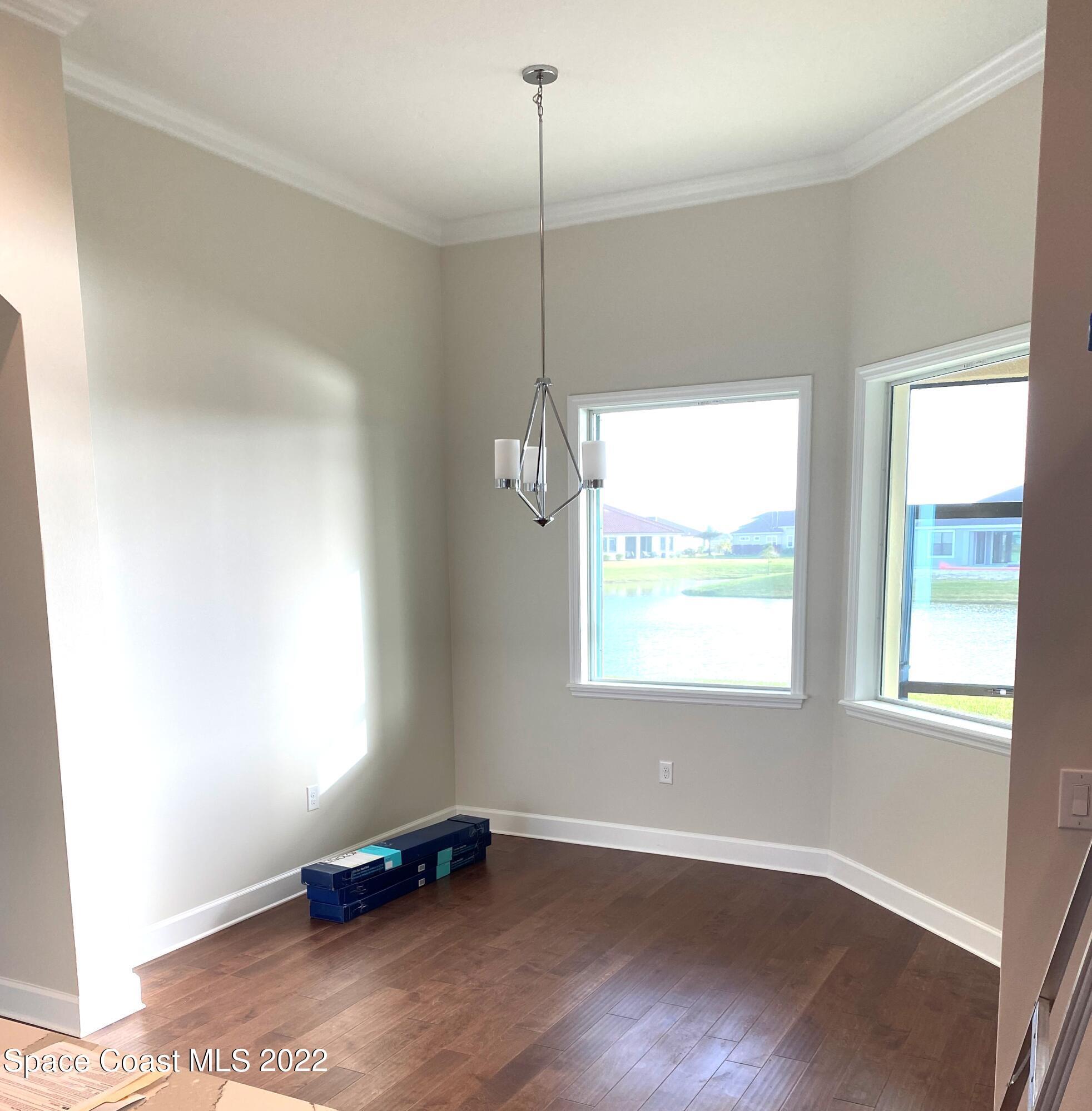 8321 Paragrass Avenue Melbourne, FL 32940 - Photo 10 of 41 a room with window and a wooden floor