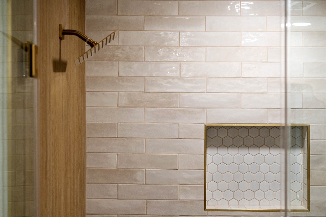 5326 Findlay Drive Pasadena, TX 77505 - Photo 37 of 50 Elegant shower details include custom subway tile, a decorative hexagon niche, and premium brushed gold hardware.