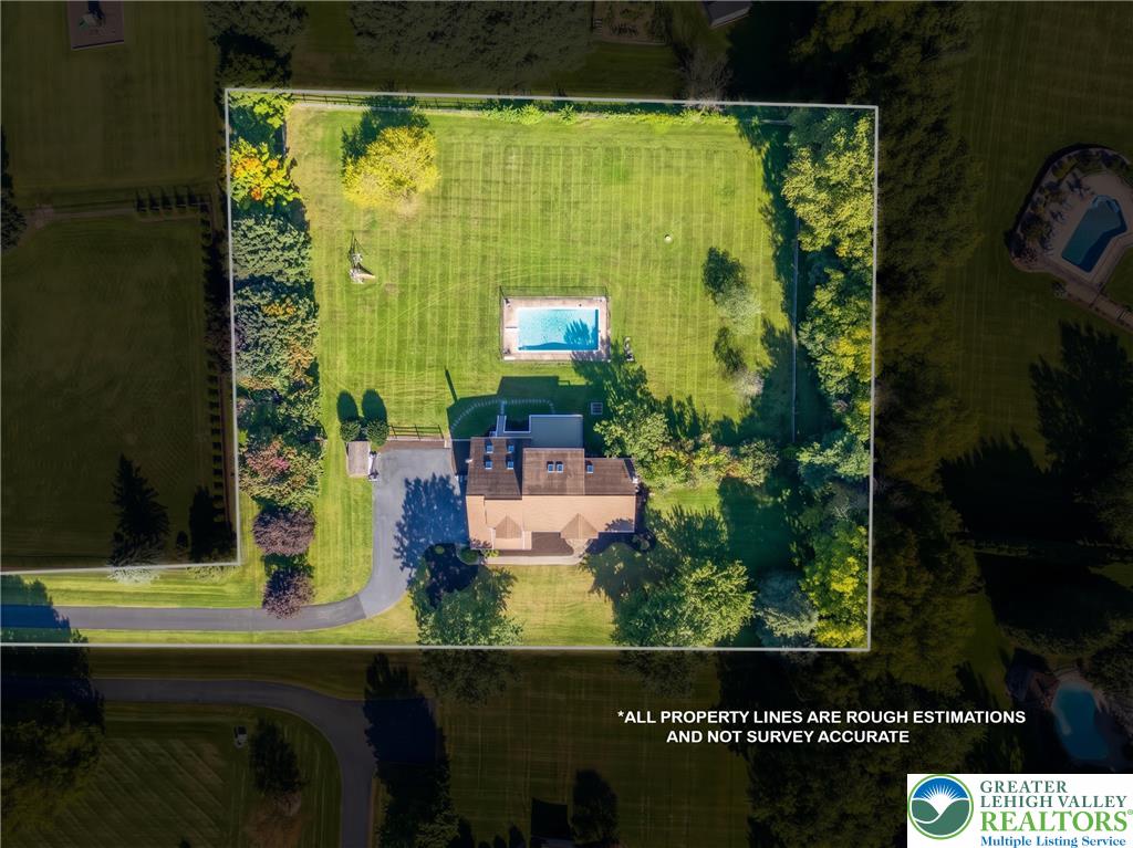 630 Clearfield Road Nazareth, PA 18064 - Photo 10 of 100 An aerial perspective reveals the expansive estate featuring a private pool and mature trees.