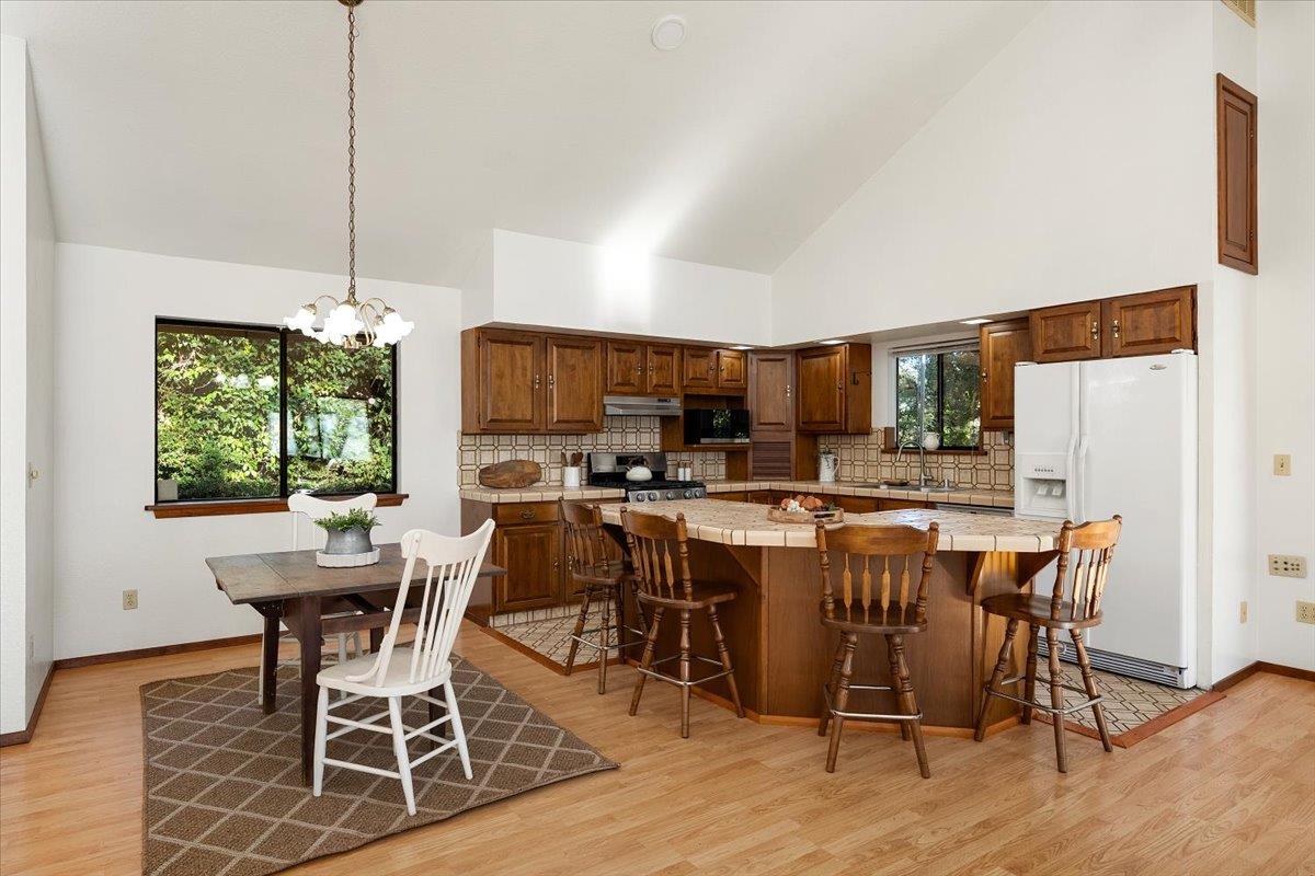 155 Pinewood Way Auburn, CA 95602 - Photo 13 of 92 a view of a dining room with furniture window and wooden floor